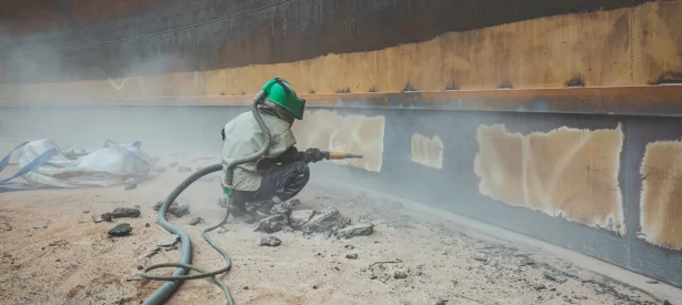 female-worker-surface-corrosion-plate-preparation-by-sand-blasting